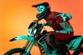 Portrait of young man, biker in full equipments riding motorbike isolated over orange studio background in neon light