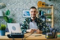 Portrait of young man blogger in recording studio near microphone smiling Royalty Free Stock Photo