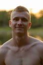 Young man with blond hair shirtless at the park outdoors Royalty Free Stock Photo