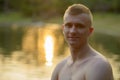 Young man with blond hair shirtless at the park outdoors Royalty Free Stock Photo