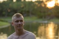 Young man with blond hair shirtless at the park outdoors Royalty Free Stock Photo