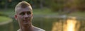 Young man with blond hair shirtless at the park outdoors Royalty Free Stock Photo