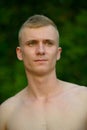 Young man with blond hair shirtless at the park outdoors Royalty Free Stock Photo