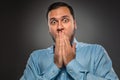 Portrait young man in blue shirt, looking with amazement Royalty Free Stock Photo