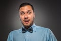 Portrait young man in blue shirt, looking with amazement Royalty Free Stock Photo