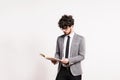 Portrait of a young man with a book in a studio on a white background. Royalty Free Stock Photo