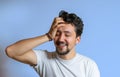 Portrait of a young man with braces smiling. A happy young man with braces on a blue background Royalty Free Stock Photo