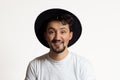 Portrait of a young man with braces smiling. A happy young man with braces and a hat on a white background Royalty Free Stock Photo