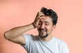 Portrait of a young man with braces smiling. A happy young man with braces on a pink background Royalty Free Stock Photo