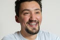 Portrait of a young man with braces smiling and laughing. A happy young man with braces on a white background Royalty Free Stock Photo