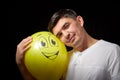 Portrait of a young man in a business suit and wigh with balloons. Positive guy posing in the studio Royalty Free Stock Photo