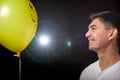 Portrait of a young man in a business suit and wigh with balloons. Positive guy posing in the studio Royalty Free Stock Photo