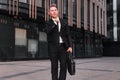 Portrait young man businessman with briefcase background business building Royalty Free Stock Photo