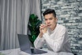 Portrait of young man businessman working  at  office with laptop on desk, looking at camera, smiling Royalty Free Stock Photo