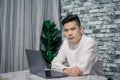 Portrait of young man businessman working  at  office with laptop on desk, looking at camera, smiling Royalty Free Stock Photo