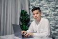 Portrait of young man businessman working  at  office with laptop on desk, looking at camera, smiling Royalty Free Stock Photo