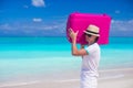 Portrait of a young man carrying his luggage on the beach Royalty Free Stock Photo