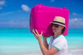 Portrait of a young man carrying his luggage on the beach Royalty Free Stock Photo