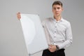 Portrait of young man with clean magnetic Board in his hands isolated on white background