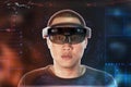 Portrait of young man with 3D virtual reality eye wear glasses hololens