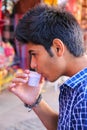 Portrait of a young man drinking chai at Johari Bazaar street in