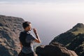 Portrait of young man drinking energy sports nutrition energy gel while sitting and resting after trail running