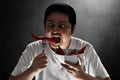 Portrait of young man eat chili pepper Royalty Free Stock Photo