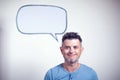 Portrait of a young man with a empty speech bubble over his head Royalty Free Stock Photo