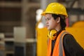 Portrait of Young man engineer wear yellow helmet in uniform standing at industrial space. male worker large industrial factory