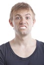 Portrait of young man with fake teeth against white background