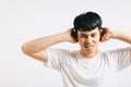 Portrait of a young man feeling stressed, covering his ears with his palms to Royalty Free Stock Photo