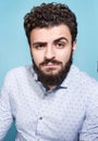 Portrait of a young man with the gaze on a blue background. Stylish appearance