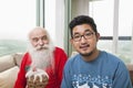 Portrait of young man with grandfather looking at him