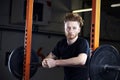 Portrait Of Young Man In Gym Lifting Weights On Barbell