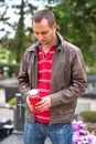 Man holding candle in the cemetery Royalty Free Stock Photo
