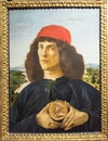 Portrait of a Young Man holding a Medallion, painting by Botticelli