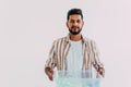 Portrait of young man holding recycling bin on white background Royalty Free Stock Photo