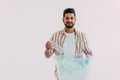 Portrait of young man holding recycling bin on white background Royalty Free Stock Photo