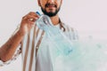 Portrait of young man holding recycling bin on white background Royalty Free Stock Photo