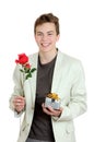 Portrait of young man holding the rose and gift over the white background Royalty Free Stock Photo