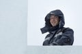 Portrait of an assembler worker in a jacket with a hood at the construction of an ice camp Royalty Free Stock Photo