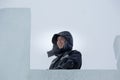 Portrait of an assembler worker in a jacket with a hood at the construction of an ice camp Royalty Free Stock Photo
