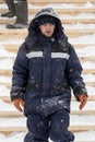 Portrait of an assembler worker in a jacket with a hood at the construction of an ice camp Royalty Free Stock Photo