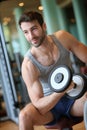 Portrait of a young man lifting weights in a fitness center Royalty Free Stock Photo