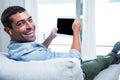 Portrait of young man listening to music while using tablet Royalty Free Stock Photo