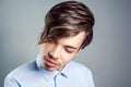 Portrait of young man with long fringe hairstyle on his eyes. Royalty Free Stock Photo