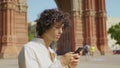 Portrait of young man looking mobile phone outdoor. Focused guy using smartphone Royalty Free Stock Photo