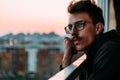 Portrait of a young man looking at sunset from a balcony Royalty Free Stock Photo