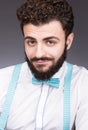 Portrait of a young man with a mysterious smile. Stylish white shirt