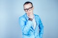 Portrait of a young man nerd gay with glasses, in a stylish suit and tie thinks